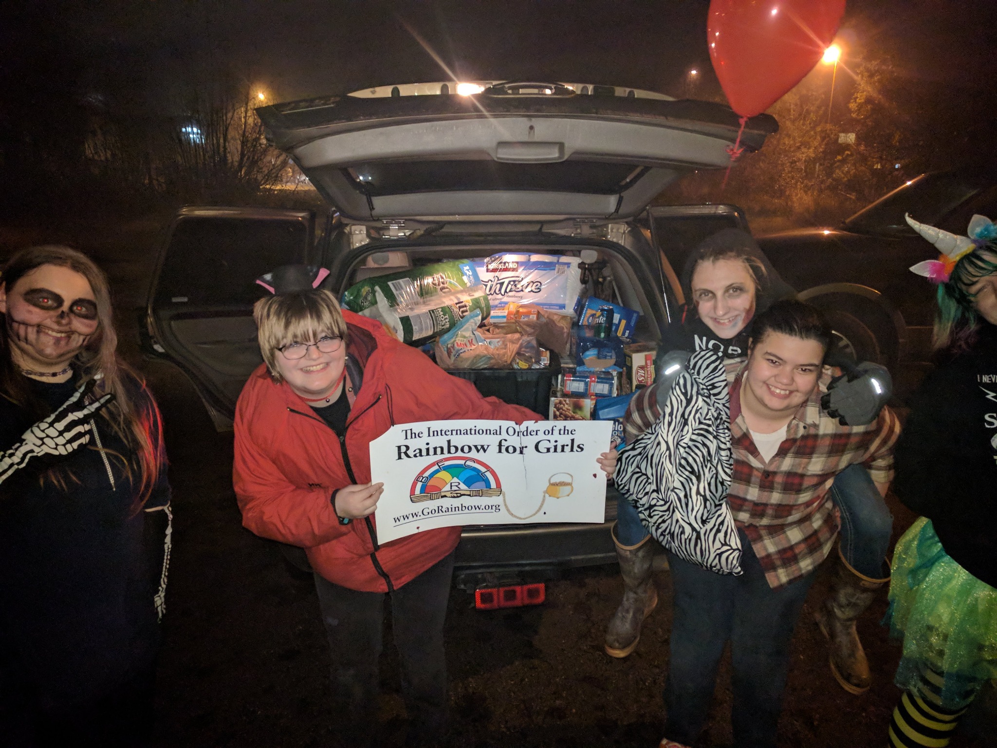 Juneau Rainbow Girls collecting food donations during a Halloween food bank drive